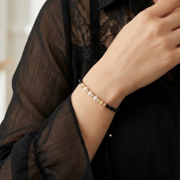 Bransoletka kule z perłą na sznurku złoto 585 